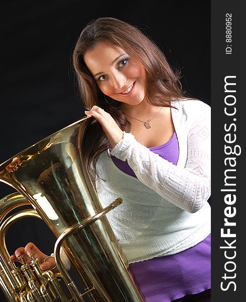 Beautiful girl with her musical instrument tuba.