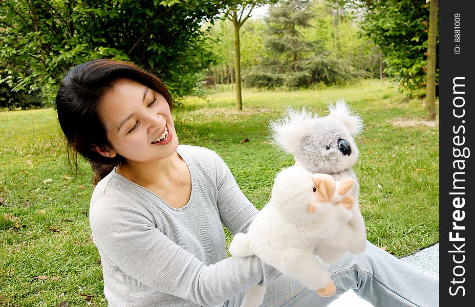 A picture of a chinese mother playing plush toys with her son, and the boy feeding the toys in roleplay. A picture of a chinese mother playing plush toys with her son, and the boy feeding the toys in roleplay