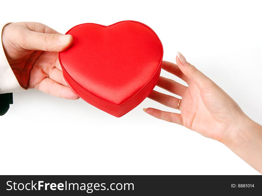 The man's hand gives heart to a female hand. Isolated on a white background. The man's hand gives heart to a female hand. Isolated on a white background