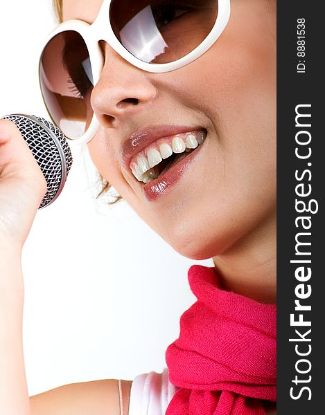 Portrait of a happy singing woman with a microphone. Portrait of a happy singing woman with a microphone