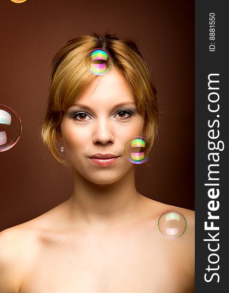 Beauty portrait of a young woman with soap bubbles