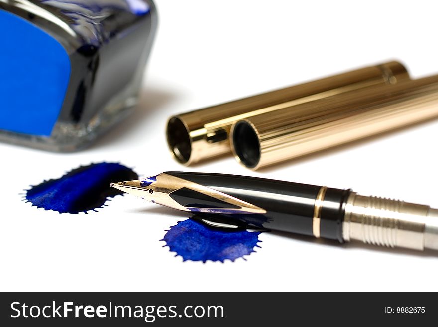 Filling of a golden pen with blue ink isolated on white. Filling of a golden pen with blue ink isolated on white