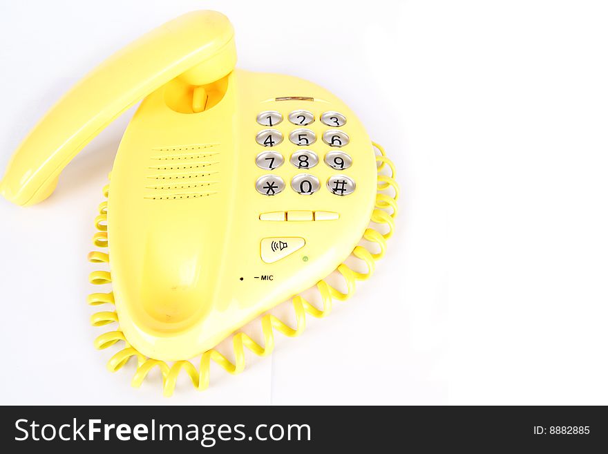 A yellow telephone on white background