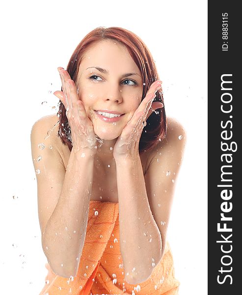 Young woman washing her face with water. Young woman washing her face with water