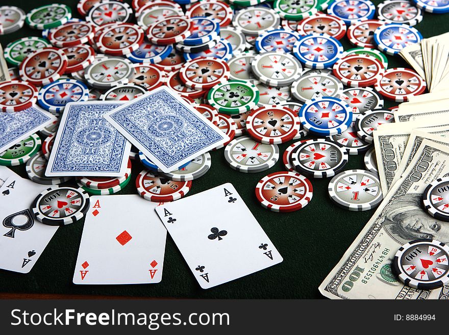 Aces, dollars and chips lying on the poker table