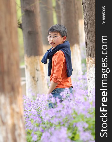 Chinese Boy Standing In The Grove