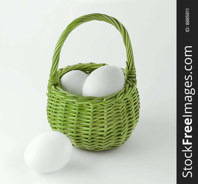 White eggs in the green basket. White eggs in the green basket