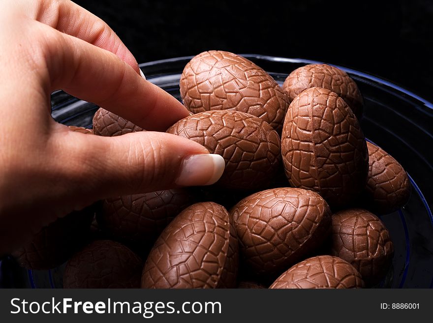 Fingers Taking Chocolate Eggs