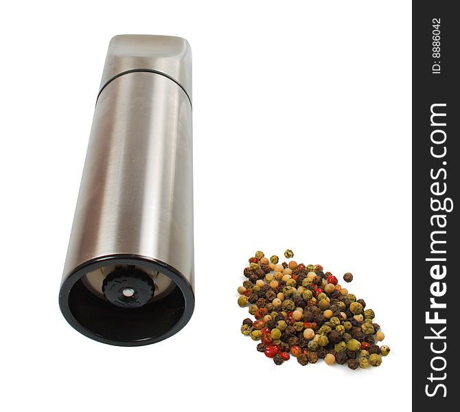 Steel kitchen mill with 4 kinds of pepper seeds isolated over white