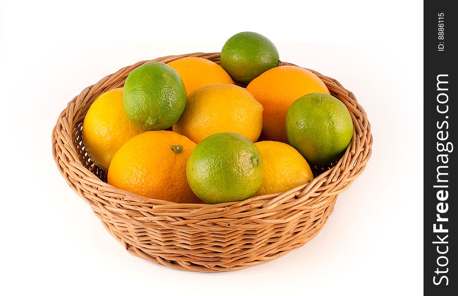 Lemons, limes and oranges in an  wooden basket. Lemons, limes and oranges in an  wooden basket.