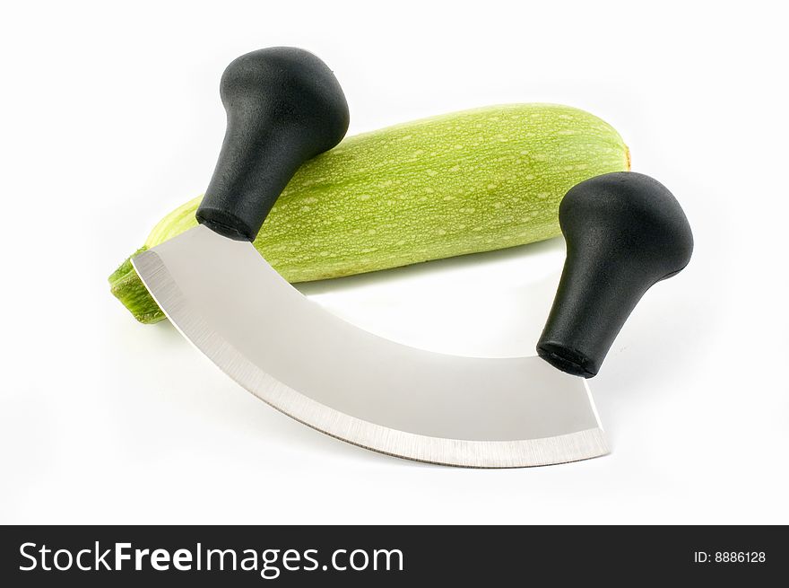 Chopping knife and courgette isolated on white