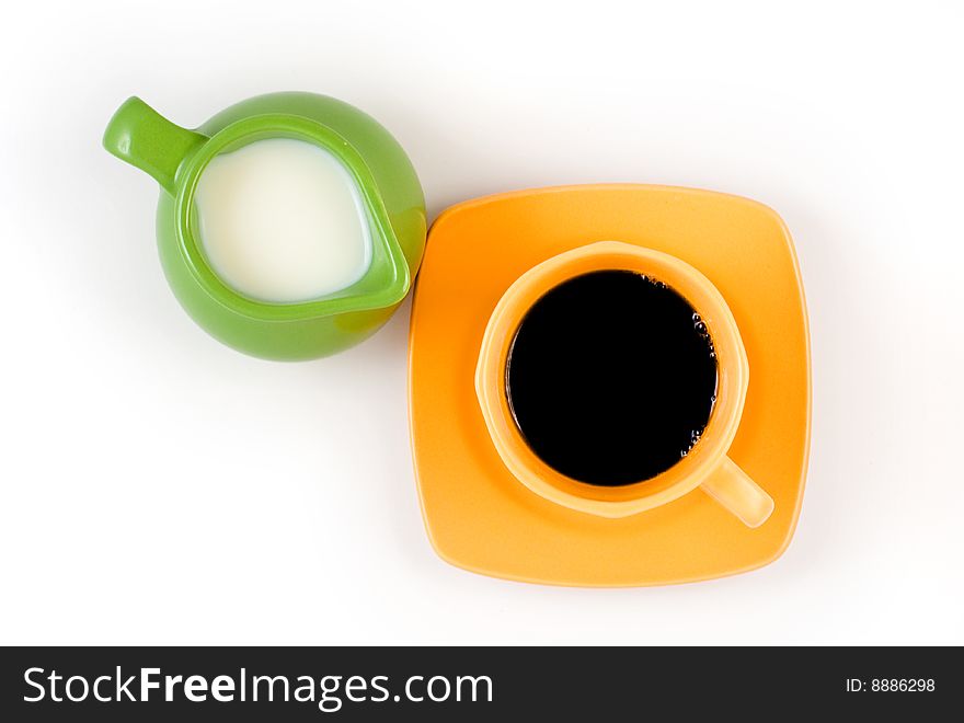 A cup of milk next to a cup of coffee isolated on white. A cup of milk next to a cup of coffee isolated on white.