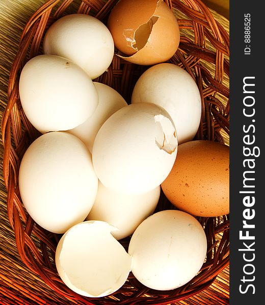 Eggs chicken whole and beaten in one basket. Eggs chicken whole and beaten in one basket