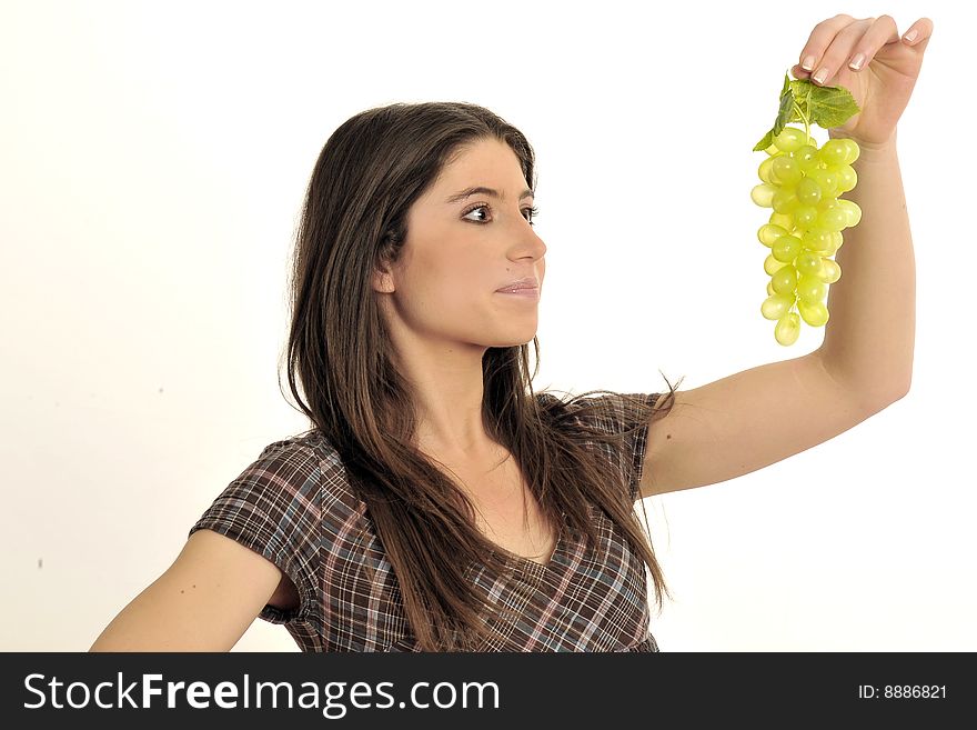 Half body view of lovely young girl in casual wear, eating fresh grape. Isolated on white background. Half body view of lovely young girl in casual wear, eating fresh grape. Isolated on white background.