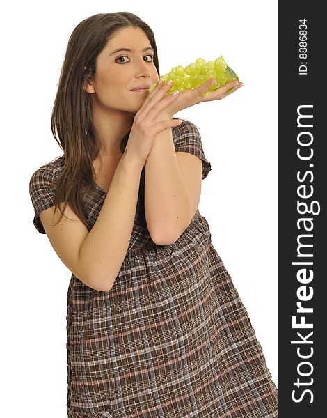 Half body view of lovely young girl in casual wear, eating fresh grape. Isolated on white background. Half body view of lovely young girl in casual wear, eating fresh grape. Isolated on white background.