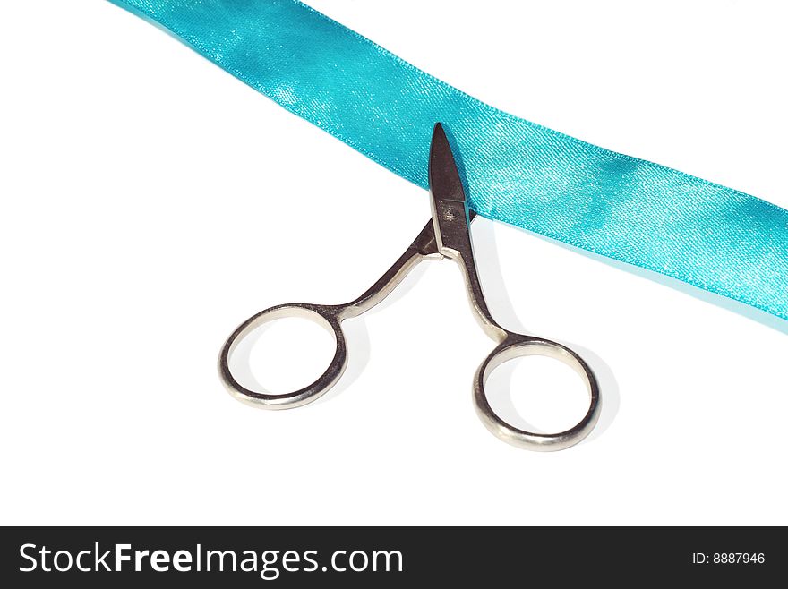 Scissors cut blue robbon on white. Scissors cut blue robbon on white