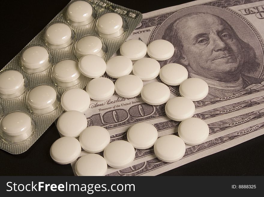 Medicine pills and dollar, concept of high cost medicine bill. Medicine pills and dollar, concept of high cost medicine bill