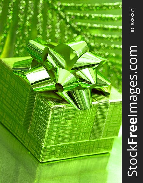 Gift box on green background with leaf