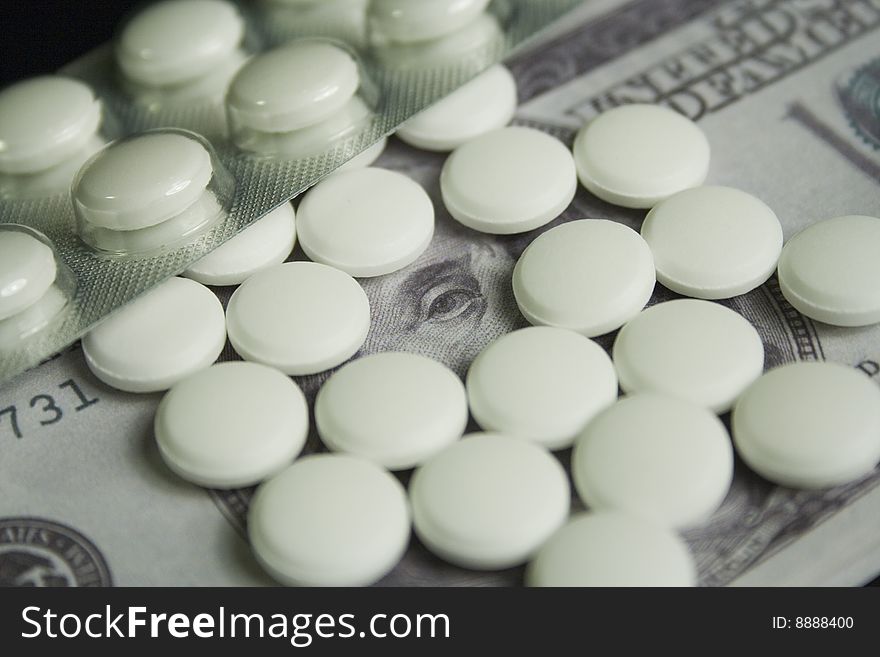 Medicine pills and dollar, concept of high cost medicine bill. Medicine pills and dollar, concept of high cost medicine bill