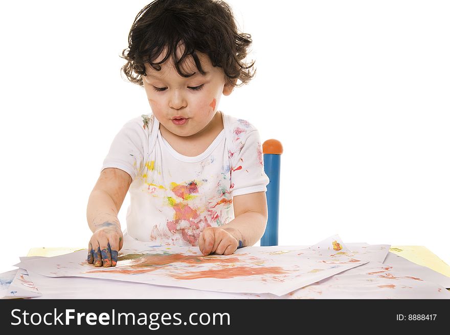 Little boy painting with paints for hands