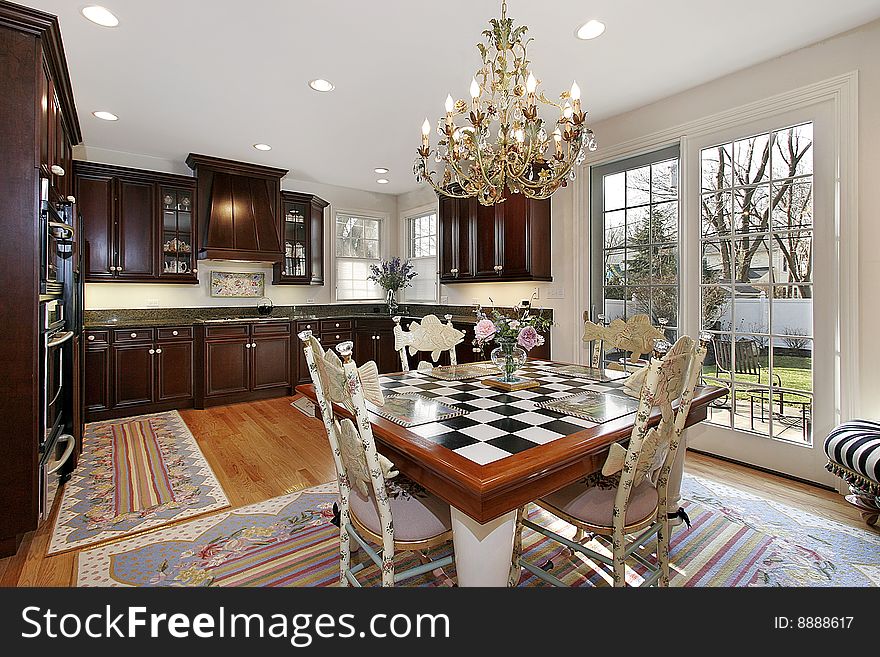 Kitchen and eating area with checkerboard table. Kitchen and eating area with checkerboard table