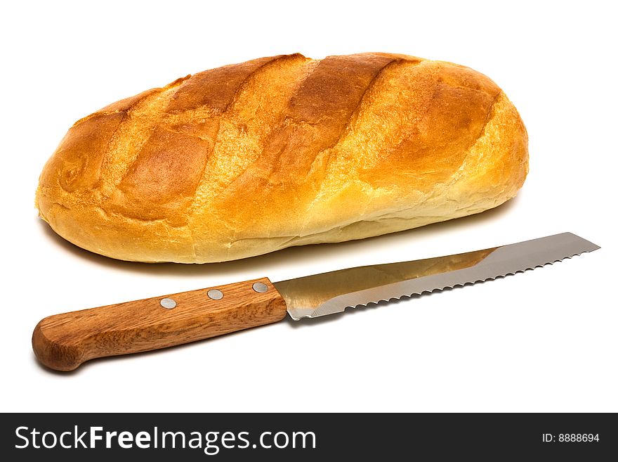 Fresh bread and knife on a white background