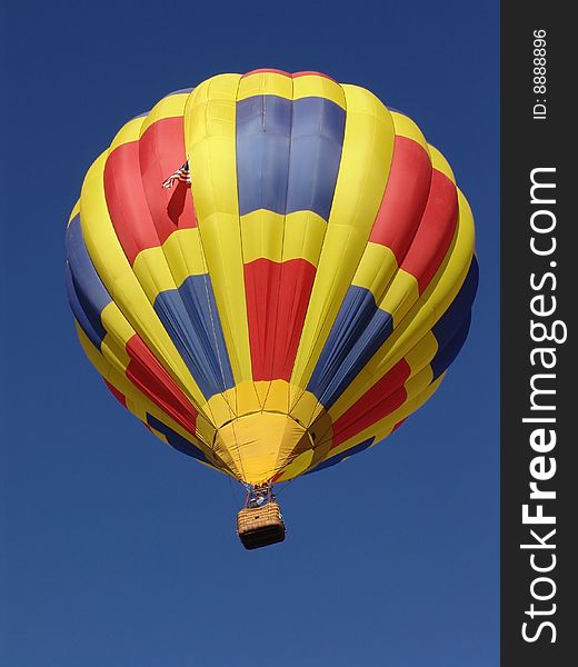 A hot air balloon against the blue sky. A hot air balloon against the blue sky