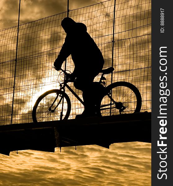 Biker On Suspension Bridge