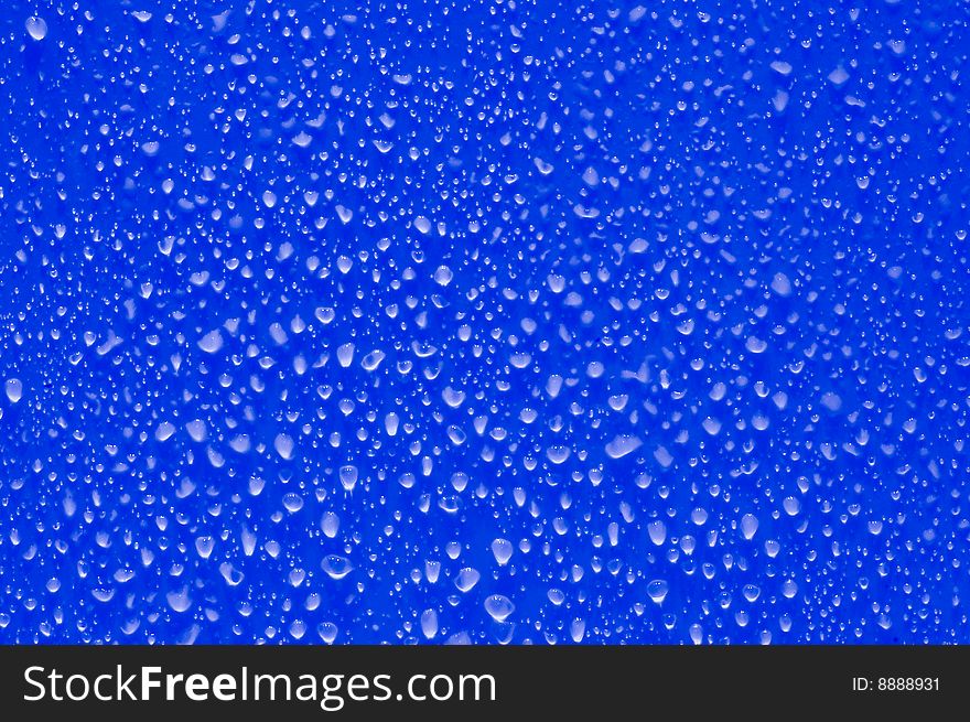 Little drops of water on blue surface. Little drops of water on blue surface