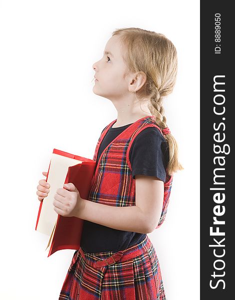 Serious schoolgirl with red book over white. Serious schoolgirl with red book over white