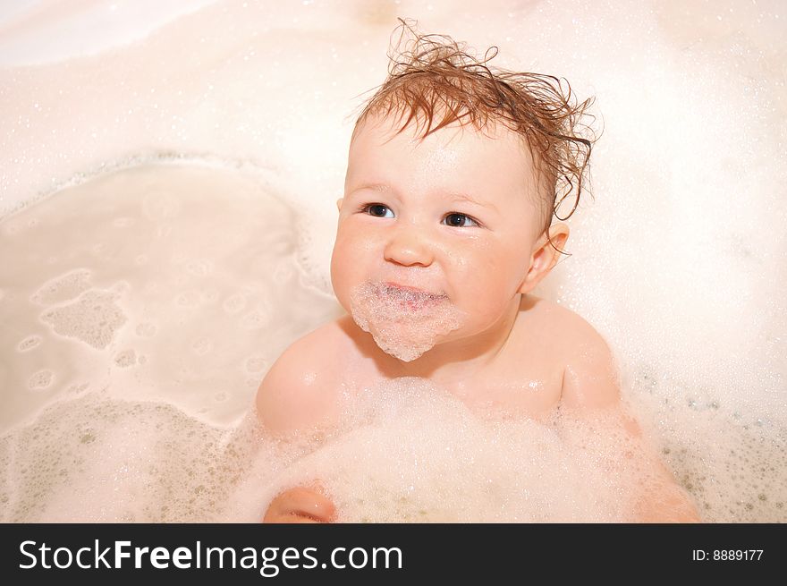 Portrait of the little girl in soapsuds