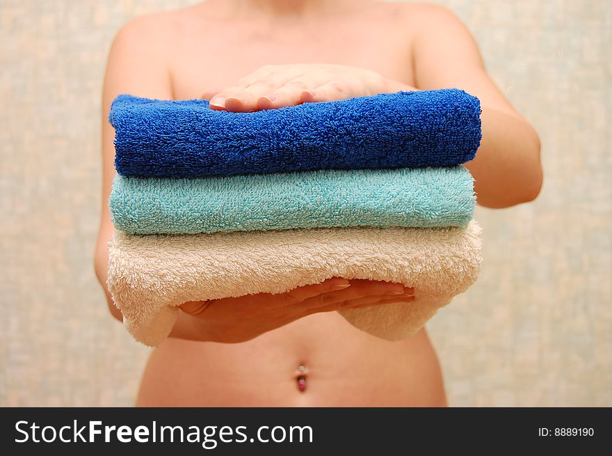 Female hands hold three clap towels