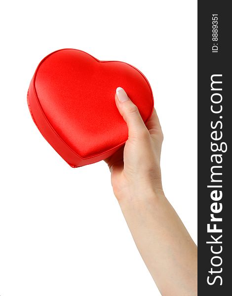 Female hand holding a heart. Isolated on a white background. Female hand holding a heart. Isolated on a white background