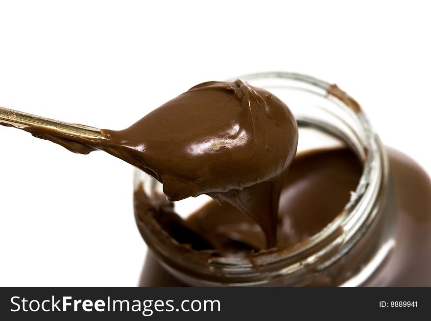 Chocolate is in a spoon isolated on white background