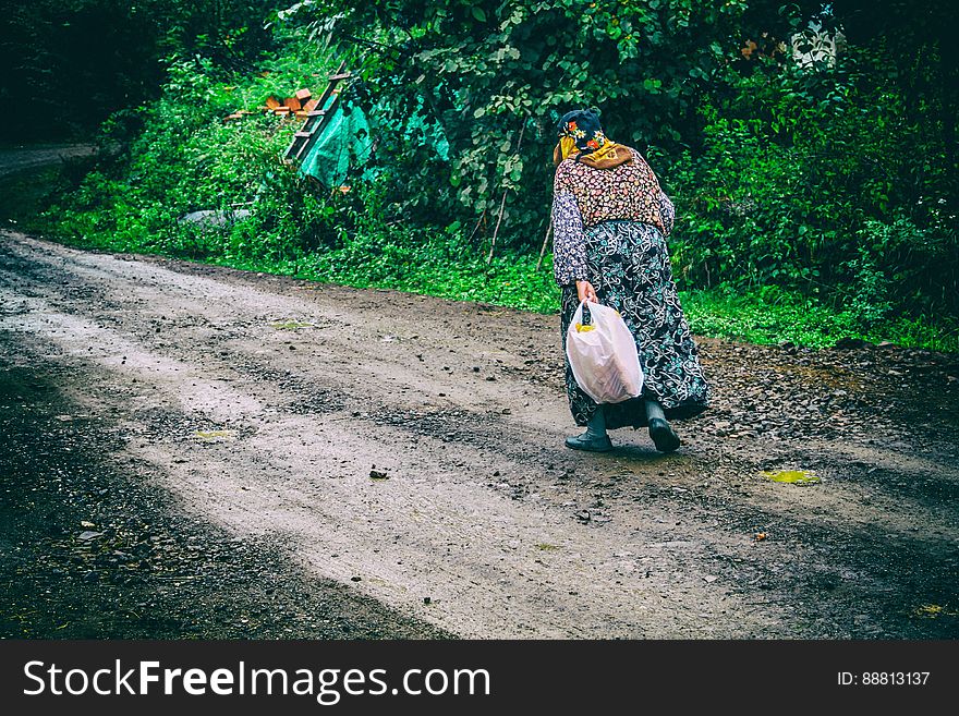 Woman Walking On Country Road