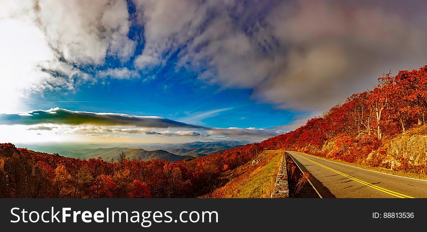 Scenic View of Mountain Road Against Cloudy Sky