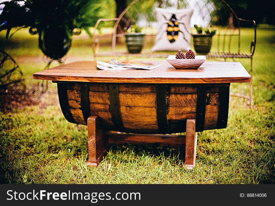A rustic wooden garden table on a lawn. A rustic wooden garden table on a lawn.