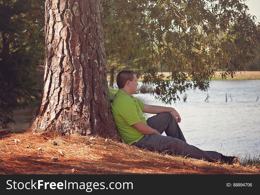 Man Leaning On Tree