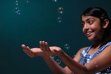 Girl Catching Lots Of Bubbles Royalty Free Stock Photo