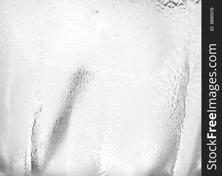 Water drops on glass with ice for background