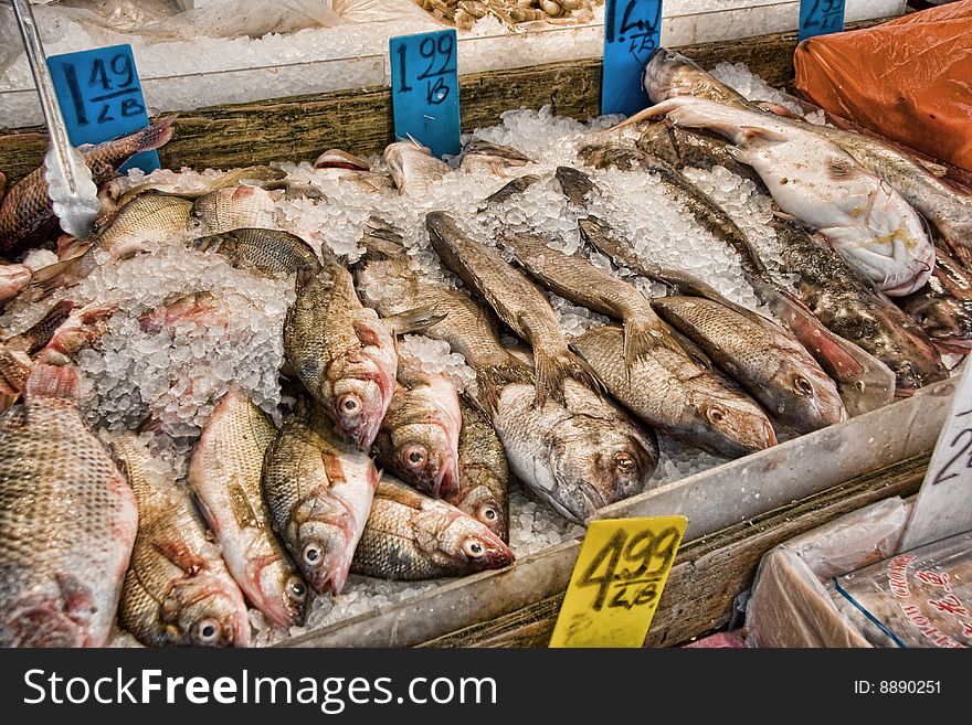 View of whole fresh fish on ice for sale a a market. View of whole fresh fish on ice for sale a a market.