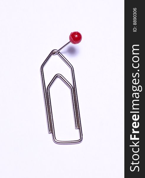 A paper clip pinned on isolated white background