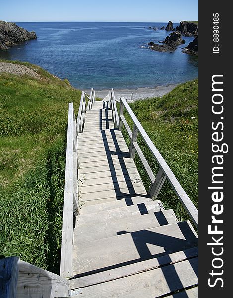 Stairs leading down cliffs to a beach below. Stairs leading down cliffs to a beach below