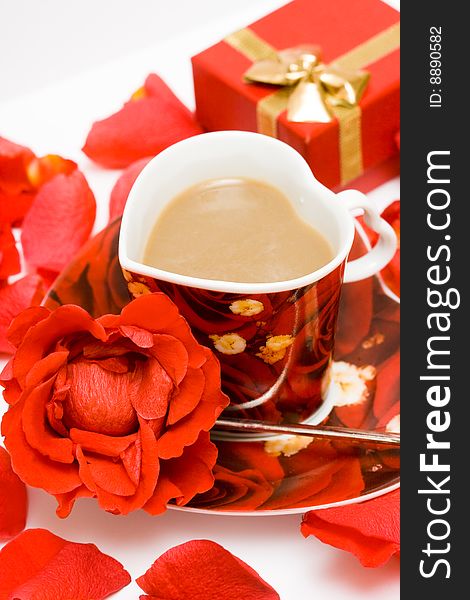 Red cup of coffee with roses