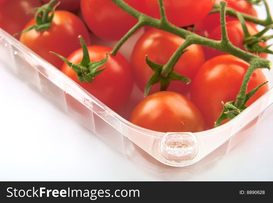 Close up of some Cherry tomatoes on a plastic bag isolated on white background