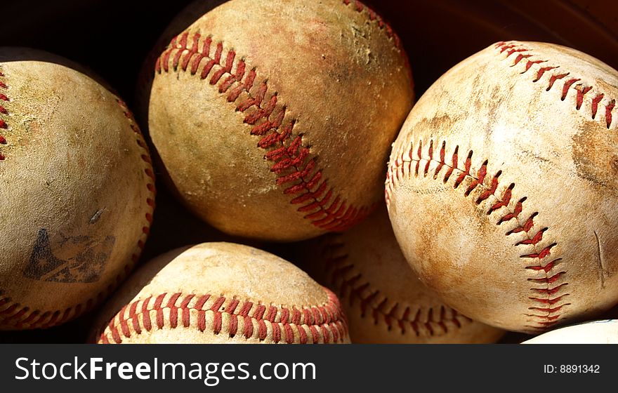 Old baseballs in a bucket after a long season