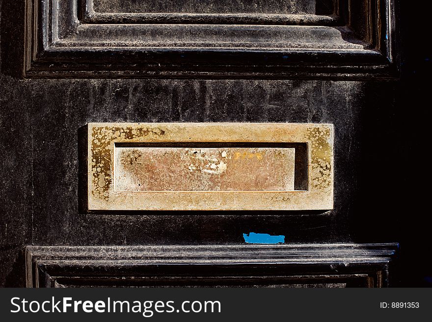 Black door gold worn letterbox