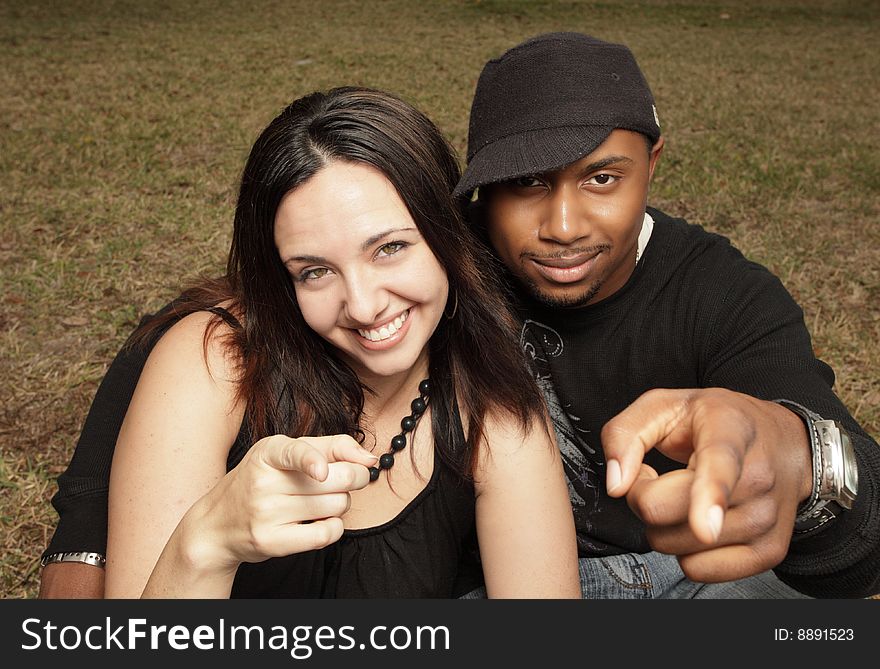 Young Couple Pointing At The Camera