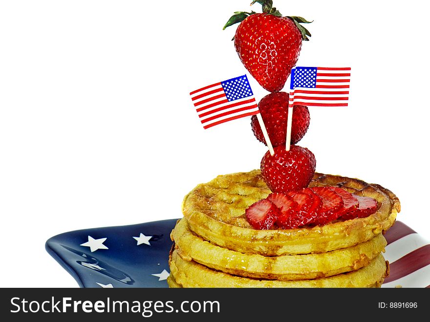 Flags in a strawberry on waffles. Flags in a strawberry on waffles.