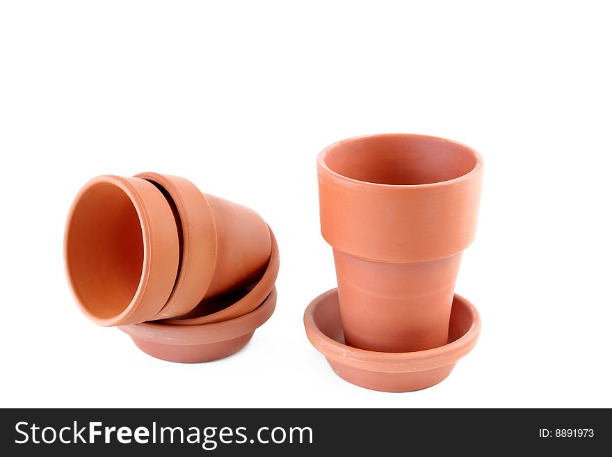 Empty terracotta flower pots on a white background with copy space.